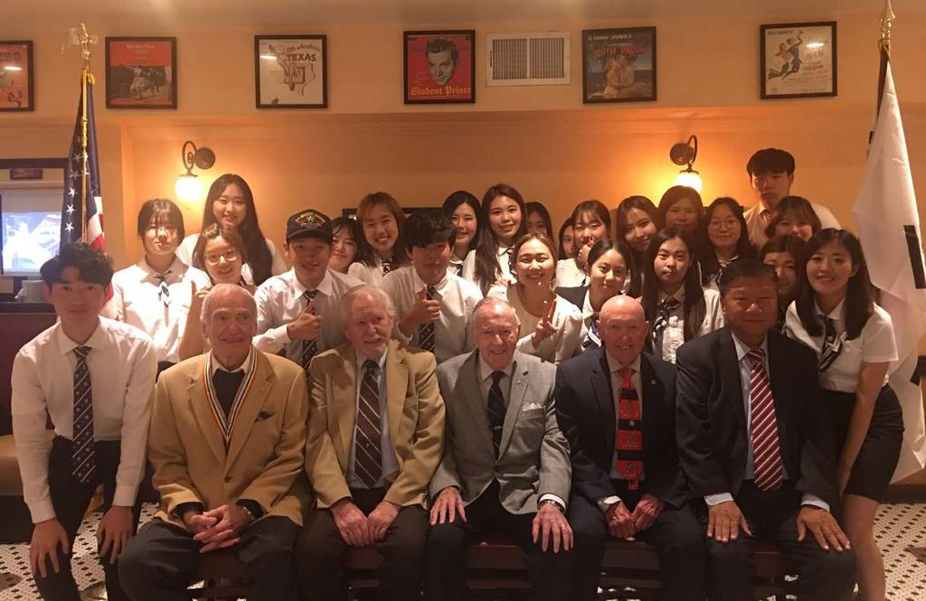 org A Memorable Meeting of Past and Present Young Korean students pose with (from L) Korean War veterans Richard Friedman, Joseph Riley, Donald Reid, and Wallace Stewart, and KWMF Vice President Man
