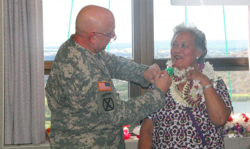 PAGE 4 Dermatology nurse celebrates 50 years of federal service at TAMC Inez Remigio, dermatology nurse, receives her 50-year federal service pin from Col.