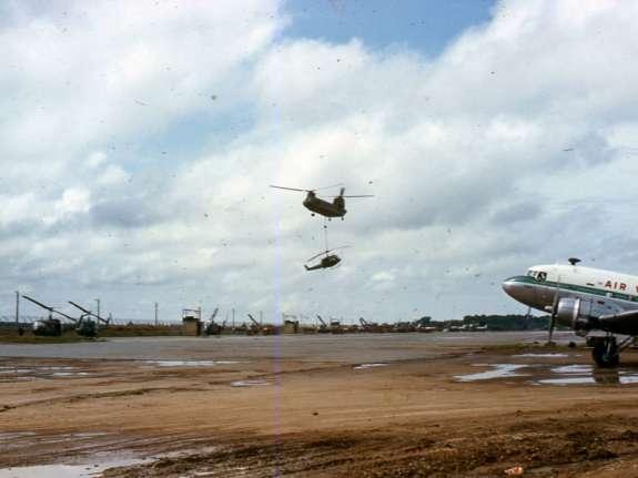 Soc Trang Army Airfield Here a CH-47 demonstrates its lifting ability by carrying a disabled Huey.