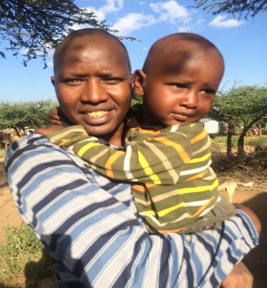 Meet your destination manager, MANDO's director Michael Sayo (shown here with one of his sons) was born and raised in Eremit, one of the communities MANDO supports.