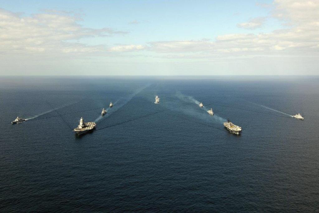 India's modified Kiev-class aircraft carrier INS Vikramaditya and Centaur-class aircraft carrier INS Viraat, flanked by other Indian Navy ships, transit the Arabian Sea in January 2014 en route to