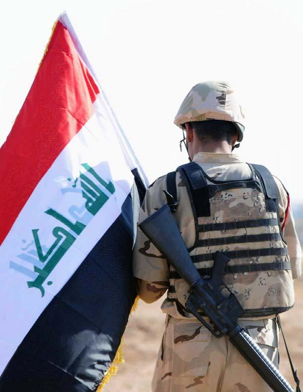 An Iraqi soldier with 2nd Battalion, 28th Brigade, 7th Iraqi Army Division waves a flag to indicate successful completion of a mission, Jan.
