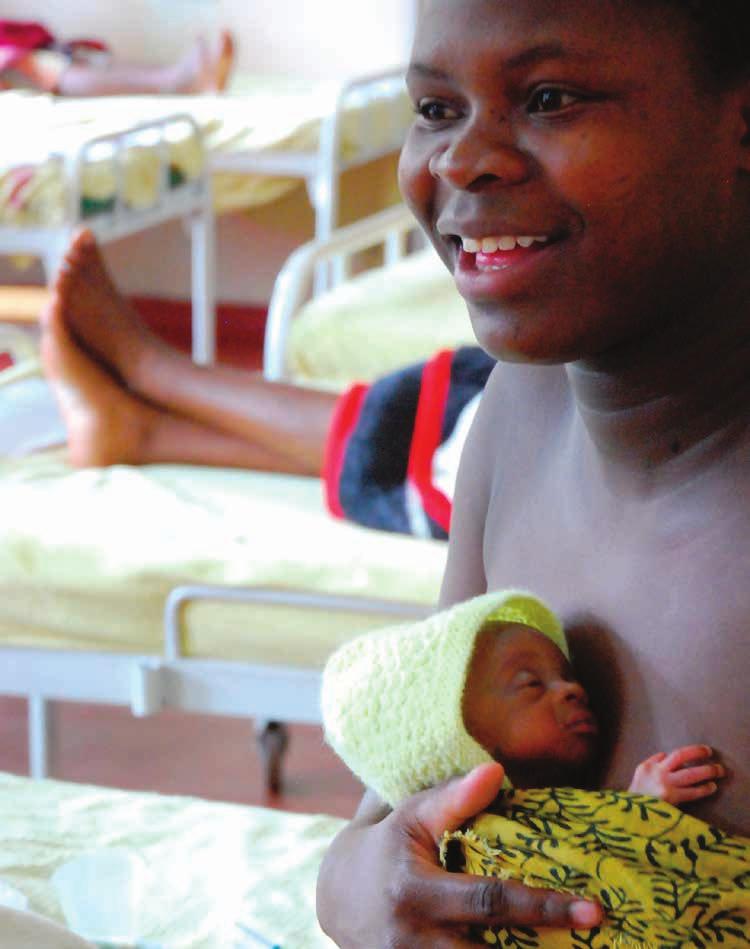 Photo: In April 2010, a mother demonstrates the Kangaroo Mother Care