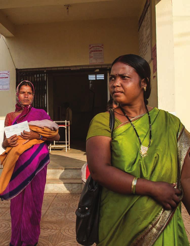 Photo: An Asha worker comes out with Chandmuri Terkey and her newborn baby at the