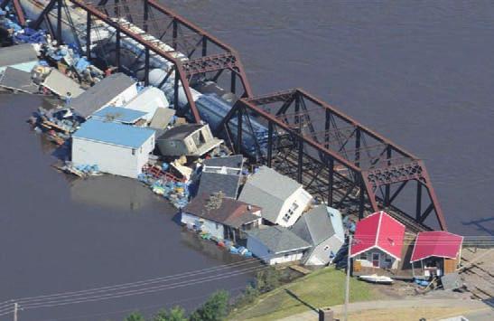 Photo courtesy of Iowa Homeland Security and Emergency Management Division and the Iowa Wing, Civil Air Patrol Homes are pushed against a railroad bridge in Cedar Rapids, Iowa.