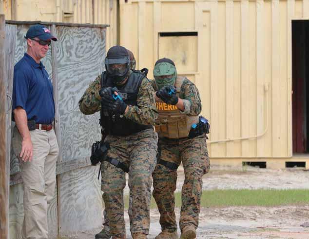 Photo by RON LESTER Above, armored law enforcement officers run drills at McCrady Training Center during S.C. SWAT Summit exercies hosted April 24-27 at Fort Jackson.
