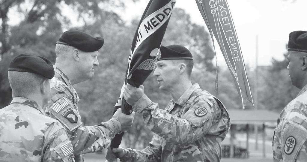 Photos by NICK SPINELLI Maj. Gen. Pete Johnson, Army Training Center and Fort Jackson commander passes the MEDDAC colors to Col.