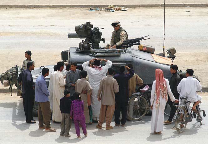 TOW in Iraq Curious Civilians Crowd Around a HMMWV with a TOW Guided Missile