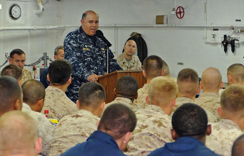 Quintanilla II, commodore of PHIBRON 5, addresses Sailors and Marines during the commemoration ceremony for the 69th anniversary of USS Makin Island s namesake raid in WWII.