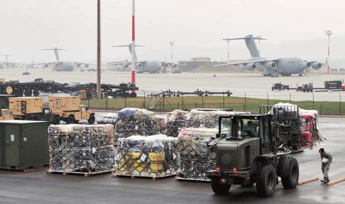 USAF photo by SrA. Caleb Pierce SrA. Justin Burger (r) directs A1C Philip Smouse (in loader) as Smouse stages cargo for Unified Protector at Ramstein AB, Germany.