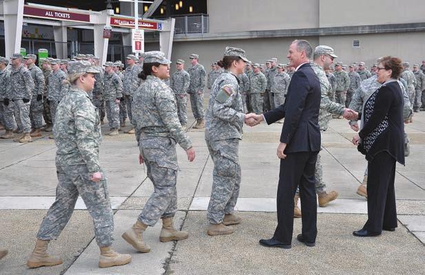Sarah Neugebauer) South Dakota Gov. Dennis Daugaard and his wife, Lynda, greet SDNG Soldiers and Airmen at FedEx Field, Jan. 19, in Washington D.C., ahead of inauguration activities.