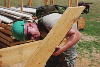 PFC James Bach, 1156th Engineer Company, New York Army National Guard, works to finish a picnic table for the children of St.