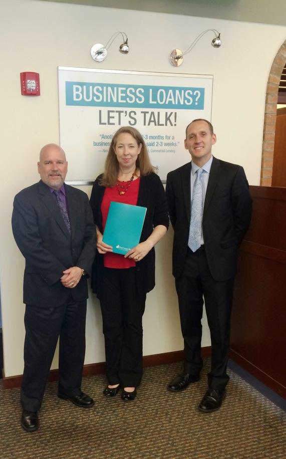 Jeff Robinson, AVP Branch Manager, and Jack Dowling, AVP Business Banking, of First County Bank, present Nancy Coughlin,