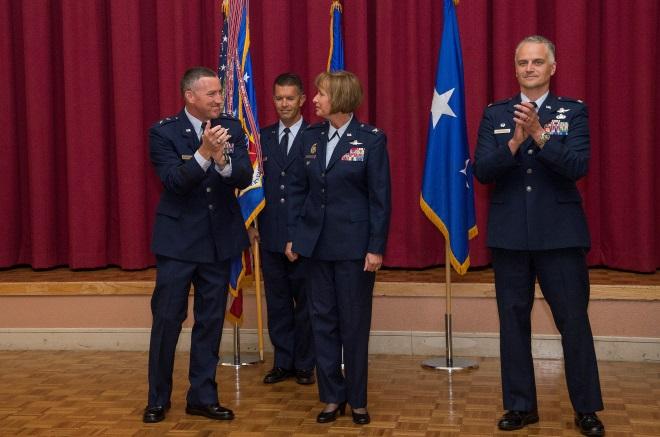 Buterbaugh unfurl the flags of the newly redesignated 688th Cyberspace Wing and 318th Cyberspace Operations Group at a ceremony on 13 September 2013.