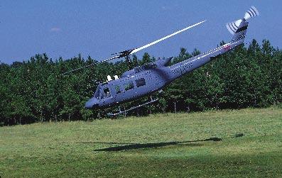blue paint scheme. At right is an older Huey showcasing a weatherworn gray finish.