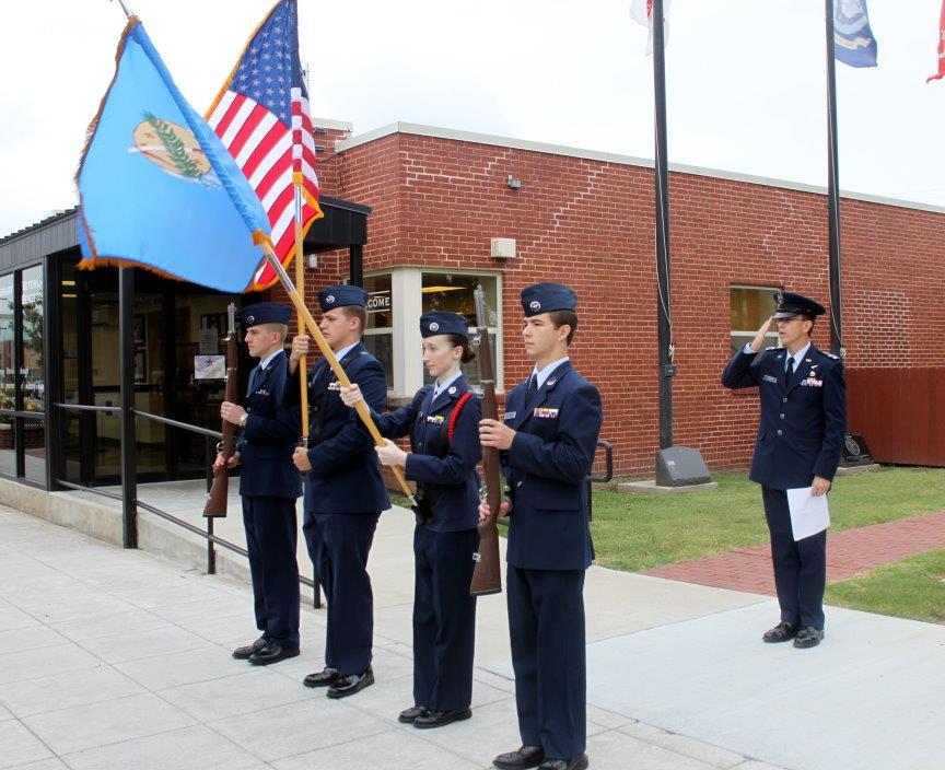 Top: Cadet Maj. Kurt LeVan salutes as the Pledge of Allegiance is recited at unveiling of Civil Air Patrol history display at Broken Arrow Military History Museum.