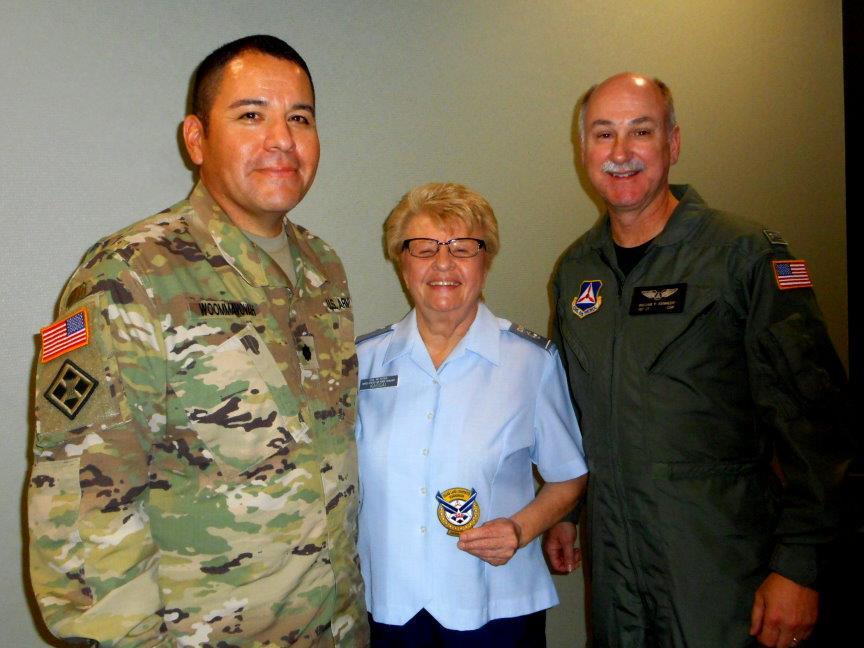 Top: (L-R) U.S. Army Lt. Col. Woommavovah, Lt. Col. Joyce Kassai (holding squadron patch) and Lt. Col. David Kennedy. (Photos: Capt. Audrey Morrow) Below: Lt. Col. Woommavovah addresses the squadron.