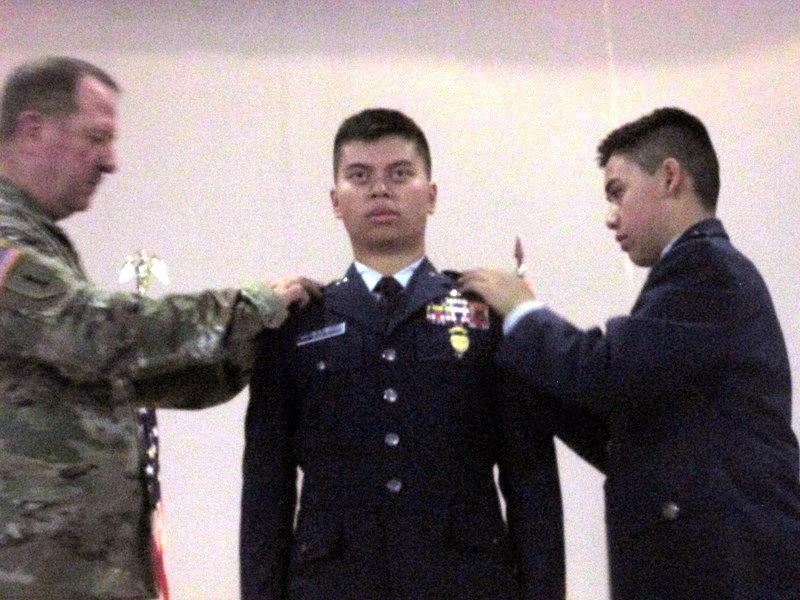 Left: Cadet Shortt (center) receives his cadet colonel insignia from Brig. Gen. Bump and his brother, Cadet 1st Lt. Owen Shortt.