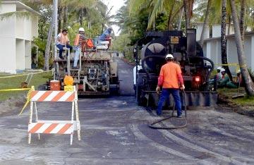 (File photo) A paving crew sprayed asphalt along Heliotrope Street as part of a