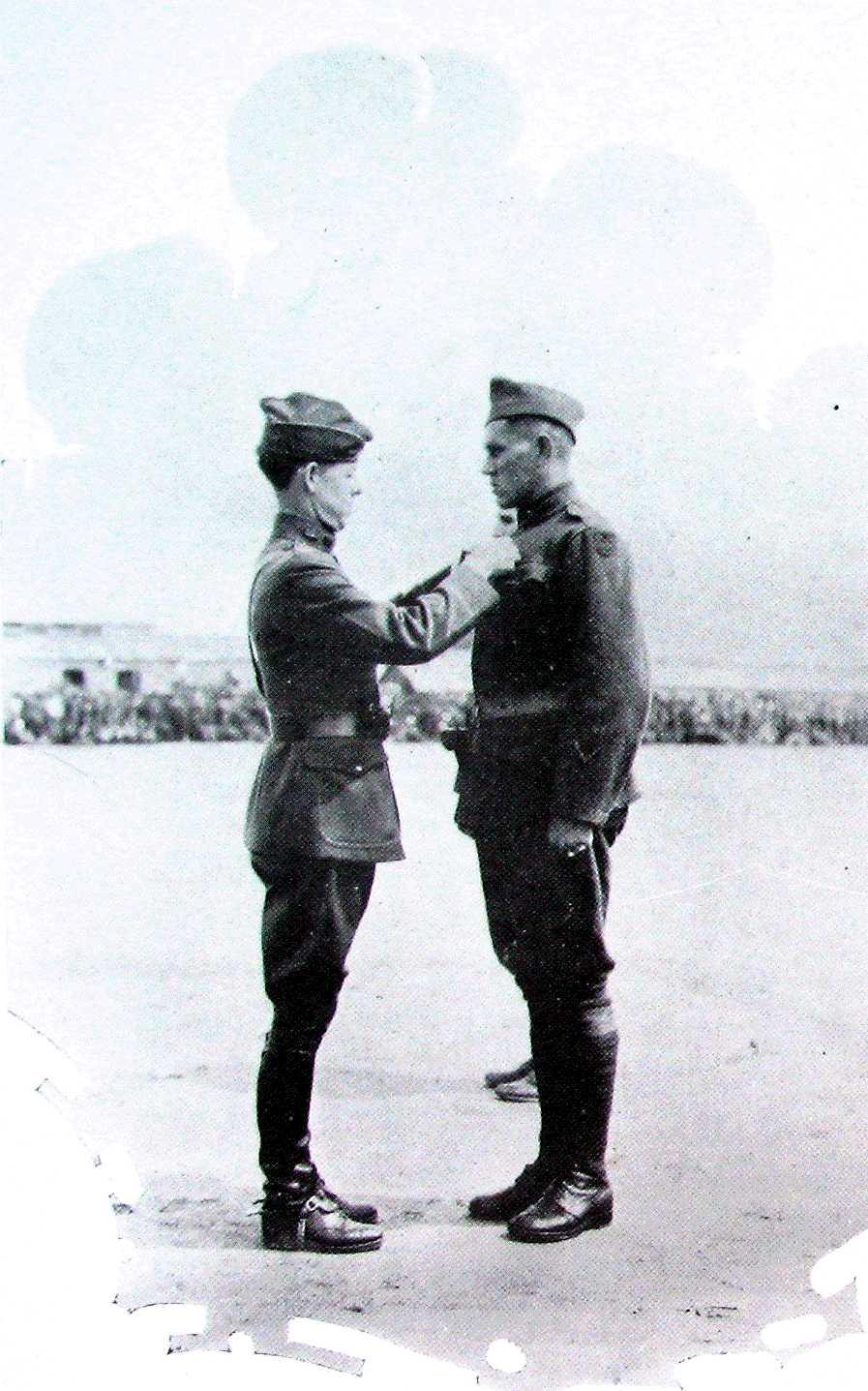 SGT. 1Cl. JAKE C. SARTAIN RECEIVES D. S. C. The picture above shows Colonel W. H. Sage, Jr., 315th Engineers, awarding Distinguished Service Cross to Sgt. 1Cl. Jake C. Sartain at St.