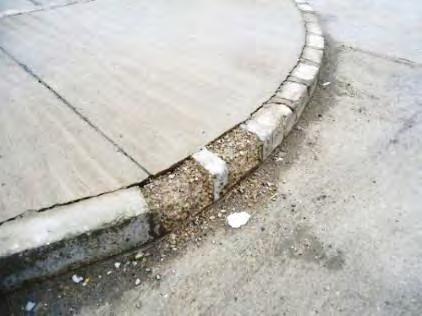 Photo 1 - Cracked Pavement Photo 2 - Crumbling Curbs Source: SIGAR, March 2015 Source: SIGAR, March 2015 Photo 3 - Cracks in Building Photo 4 - Peeling Paint on Outside Wall Source: SIGAR,
