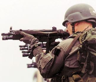 U.S. Marines, part of a combined-arms, airground task force, with MP 5 submachine guns billion for some 750,000 active troops that can be projected into overseas regions.