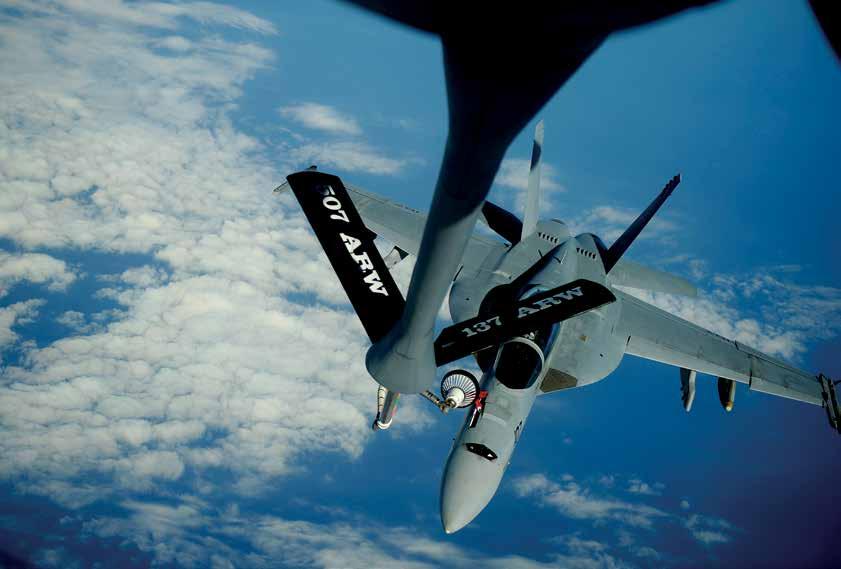 KC-135 Stratotanker assigned to 465 th Air Refueling Squadron, 507 th Air Refueling Wing, delivers fuel to F/A-18F Super Hornet assigned to Black Knights of Strike Fighter Squadron 154 supporting Rim