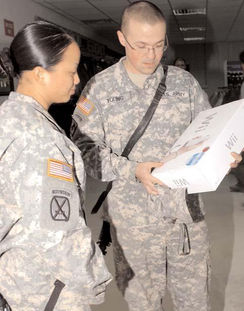 Robert Young (right), with HHC, 2nd BCT, 10th Mtn. Div., shows Sgt. Tuyen Nguyen (left), also with HHC, an item he is thinking about buying from the new Post Exchange.
