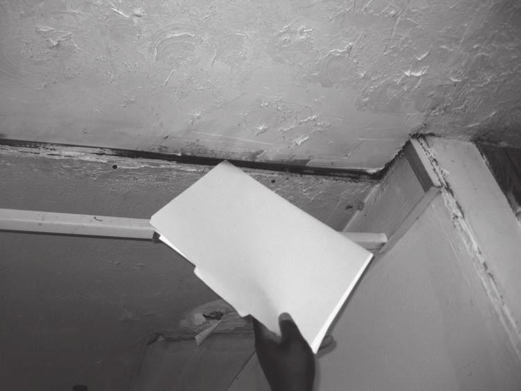 Figure 15: Pointing Out Ceiling Cracks During an Energy Audit of a Home in Georgia Source: GAO.