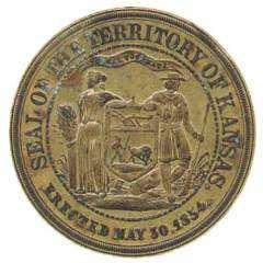 Encircling the border of the two-inch brass die is the text, SEAL OF THE TERRITORY OF KANSAS / ERECTED MAY 30, 1854.