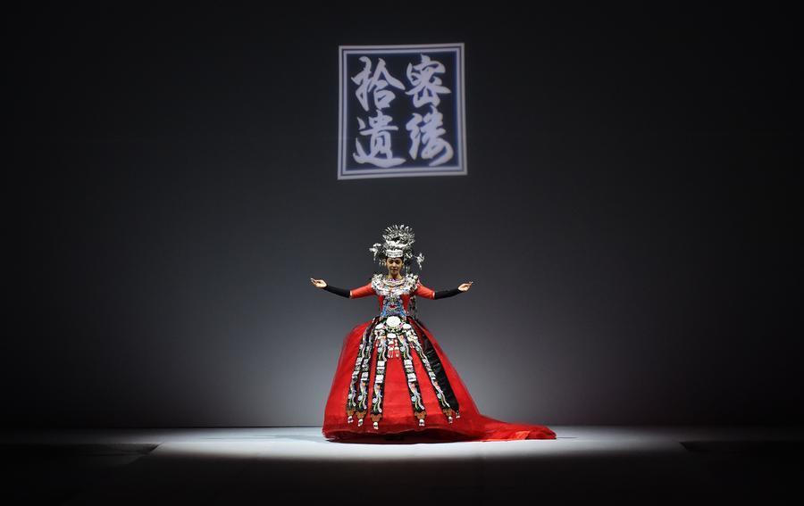 A model presents a creation by a designer from a workshop focused on China's folk