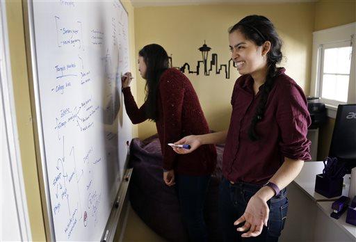 Free housing, other efforts try to attract women to tech 23 October 2015, byphuong Le and her twin sister, Karishma Mandyam, write on an "idea board" for an upcoming hack-athon in the
