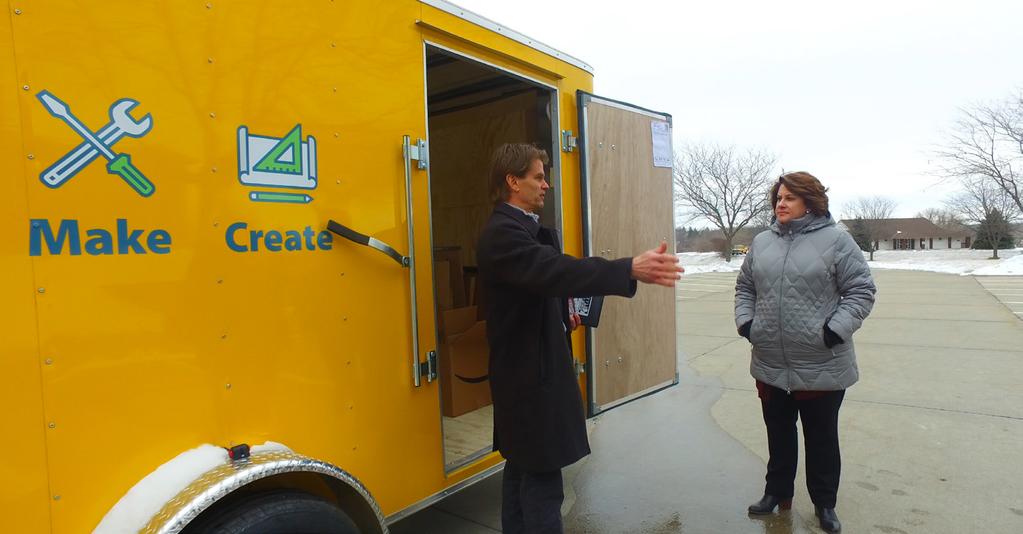 Jeff Cole, left, from Beyond School Bells talks with City Adminsitrator Brenda Gunn about the Think, Make, Create trailer at its unveiling earlier this year.