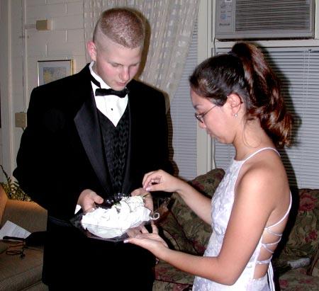 In a time-honored tradition, Eric Pichler gives Nanelle Fellows a wrist corsage before the prom Sunday night at the Yokwe Yuk Club.