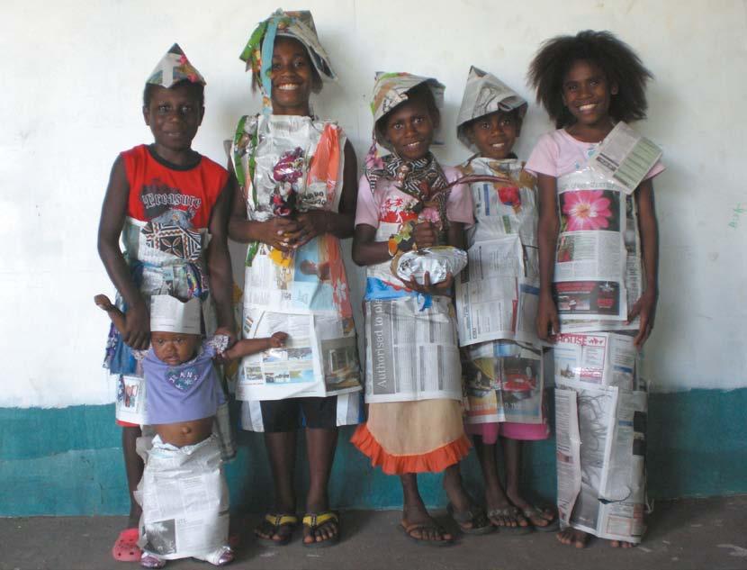 Some young members from the Wan Smolbag Literacy Class in Vanuatu (and a tiny visitor) show off their creations after a craft