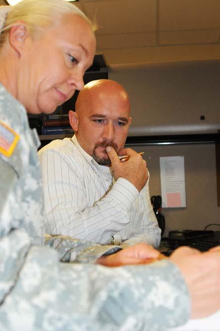 Feature Photo by Dena O Dell Sgt. 1st Class Melissa Browning, left, reviews contract actions with Reece Hockstedler June 24 at Fort Riley, Kansas.