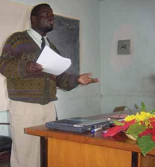 Valid International, 2004. The district health officer of Dowa, Malawi, briefs clinic and community workers about the progress of the CTC programme so far.