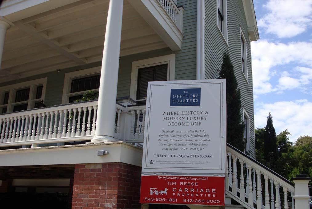 The real-estate sign below indicates available apartments