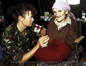 14 Sergeant from Hereford, a nurse with the Queen Alexander s Royal Army Nursing Corps, comforts a refugee who is thought to be over 100 years old, but