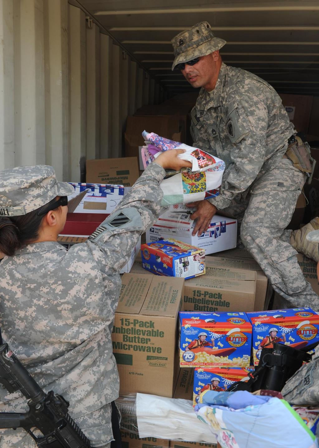 U.S. Army Photo by Spc. Gary Silverman/Released U.S. Army Sgt. 1st Class Leopoldo Banda with 486th Civil Affairs Battalion distributes treats to U.S. Soldiers with 4th Advise and Assist Brigade, 3rd Infantry Division in Camp Ramadi, Iraq, September 9, 2010.