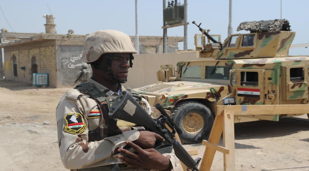 An Iraqi Arm soldier provides security at a joint Iraqi Army and Iraq Department of Border Enforcement vehicle traffic checkpoint in Maysan, Iraq, August 30, 2010. U.S.