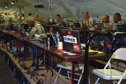 The 21st TSC staff work diligently inside the forward command post (FCP) during a training exercise.