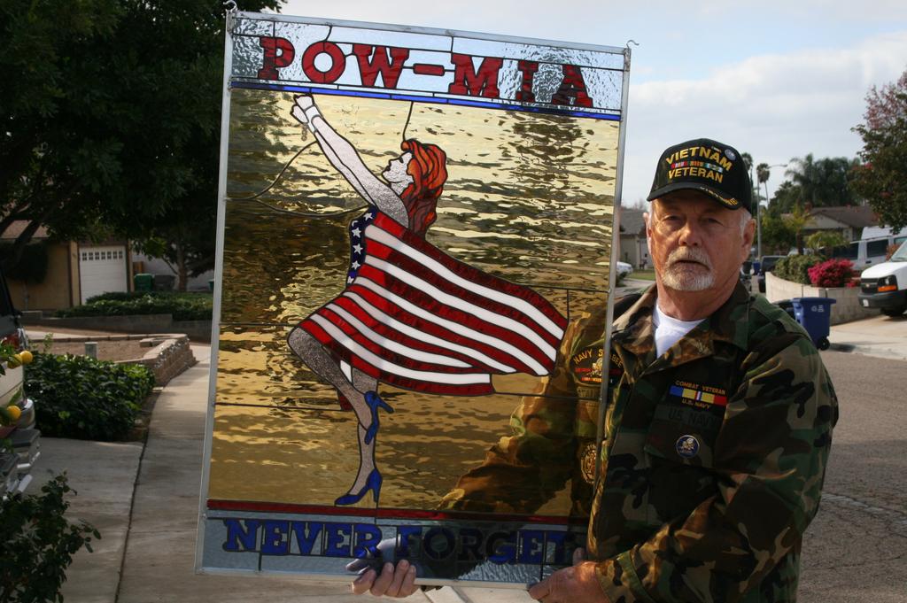Jim Stauffer (NMCB 133) with his latest project, a stained glass picture for POW-MIA. Jim had two tours in Vietnam, 1968 1969.
