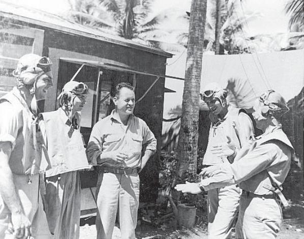 Pappy Boyington speaks with other Marines of VMF-214.