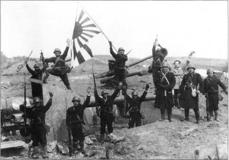 Background to war 15 Japanese troops in a victory pose at a captured Chinese artillery camp, Shanghai, November 1937.