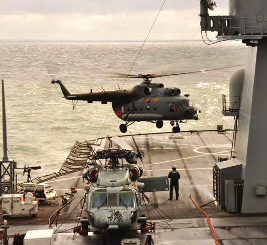 One Sea Knight hovered over the ship s flight deck just long enough for Marines to pour out of the aircraft, fast-roping to the deck below.