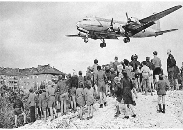 Dividing Germany U.S., Britain, and France merged their zones in 1948 to create an independent West German state. The Soviets responded by blockading land access to Berlin. The U.S. began a massive airlift of supplies that lasted almost a year.