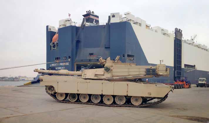 An M1A2 Abrams tank rolls off the Liberty Promise roll-on/roll-off vessel and prepares for onward movement by rail. (Photo by Capt. Robert R.