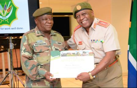 Lieutenant General Bongani Mbatha (Chief of Logistics) presenting a certificate of participation to Colonel