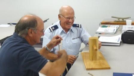 FLOTILLA MEETING - Cont d From left: Bob Young and Sep Harvin putting their heads together to get their knot right William